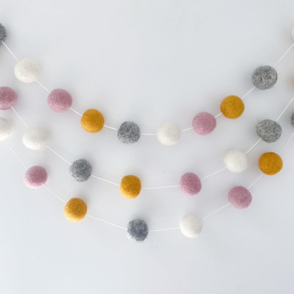 Felt Ball Pom Pom Garland In Dusty Pink, Natural Grey, Mustard and Natural White by Stone and Co